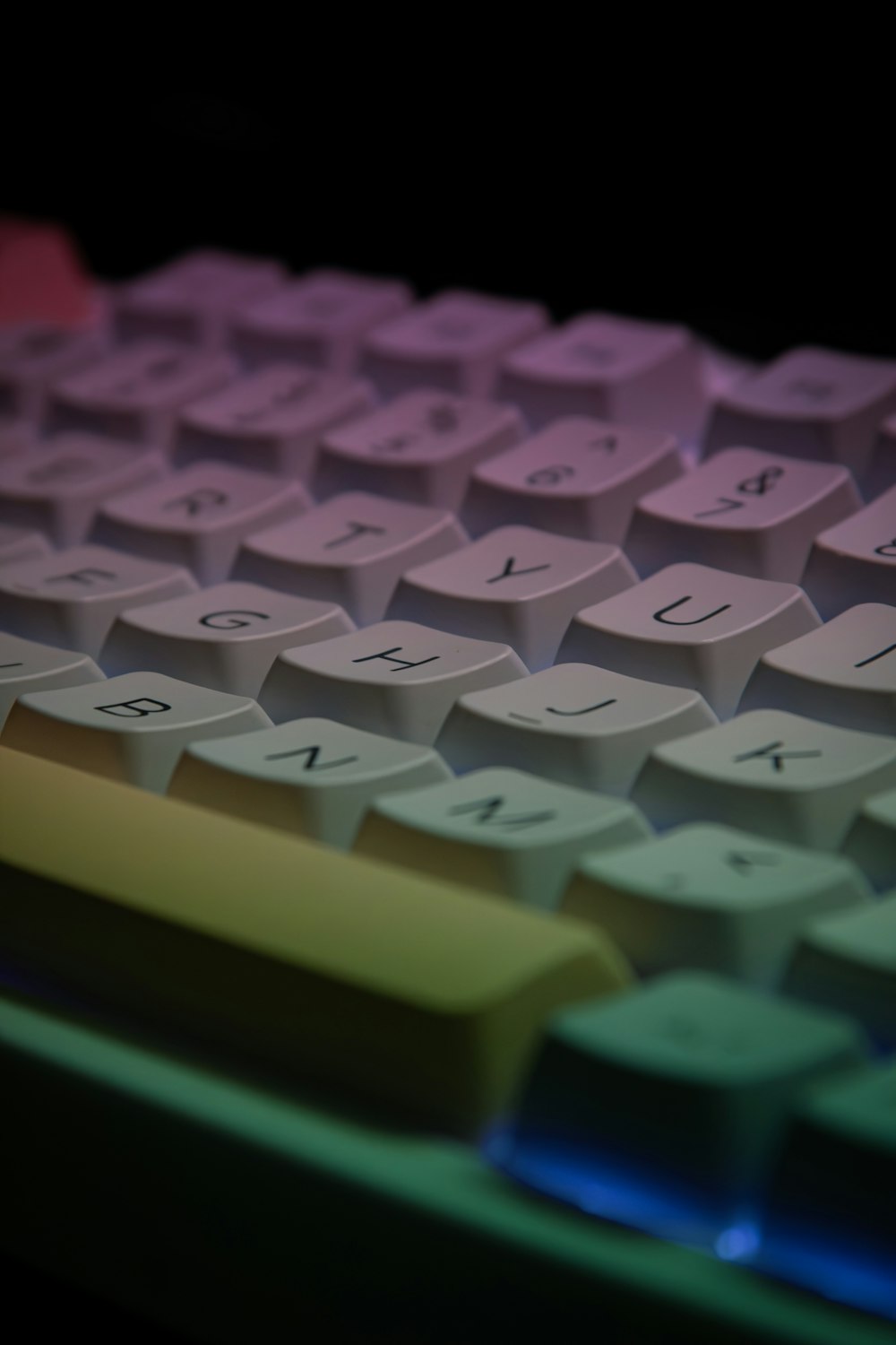 a close up of a computer keyboard with a multicolored key board