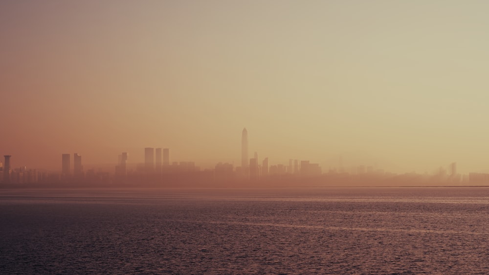 a large body of water with a city in the background