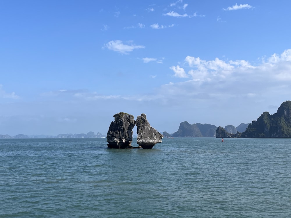 a large rock in the middle of a body of water