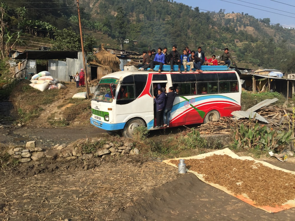 a group of people standing on top of a bus