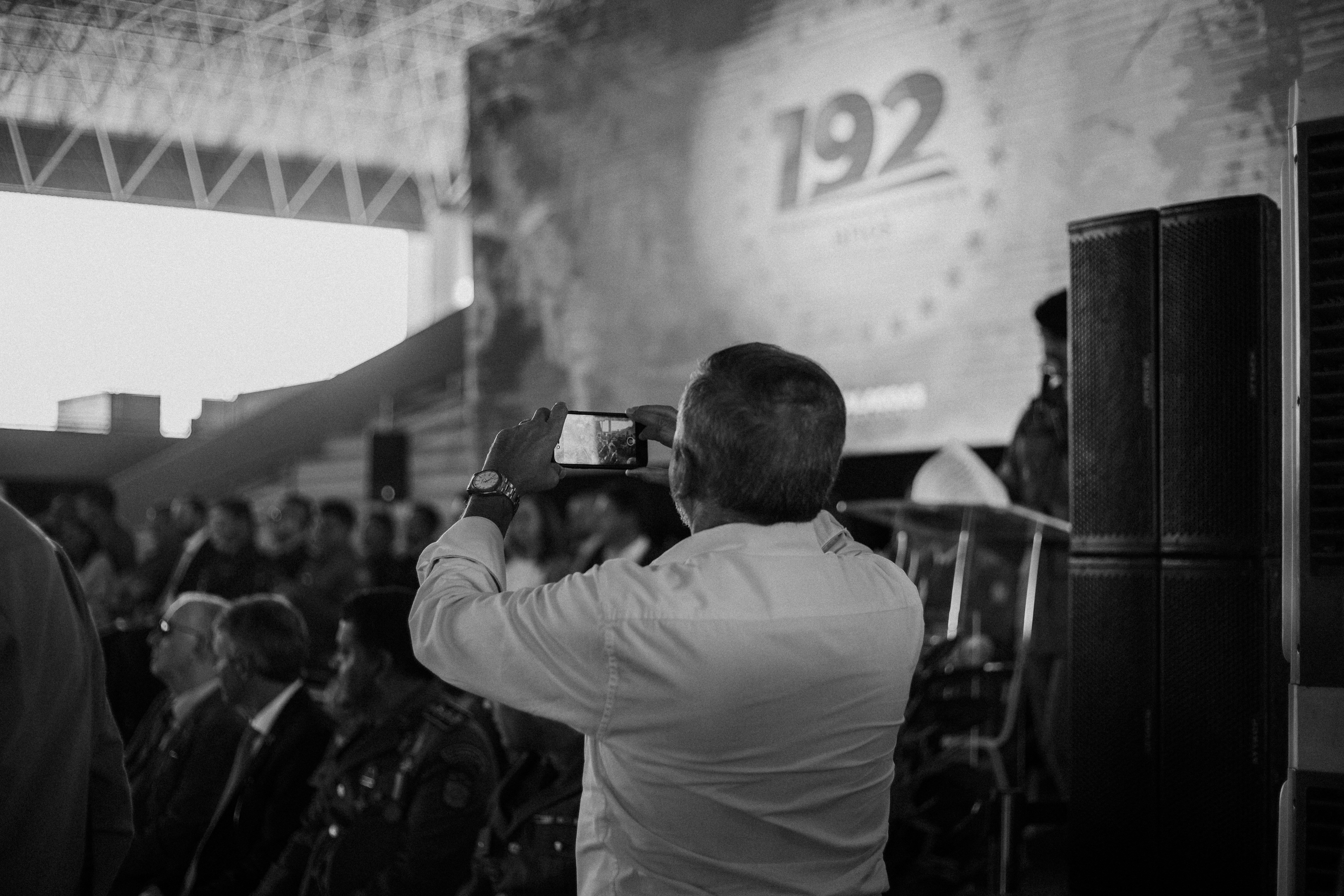 a man taking a picture of a crowd of people