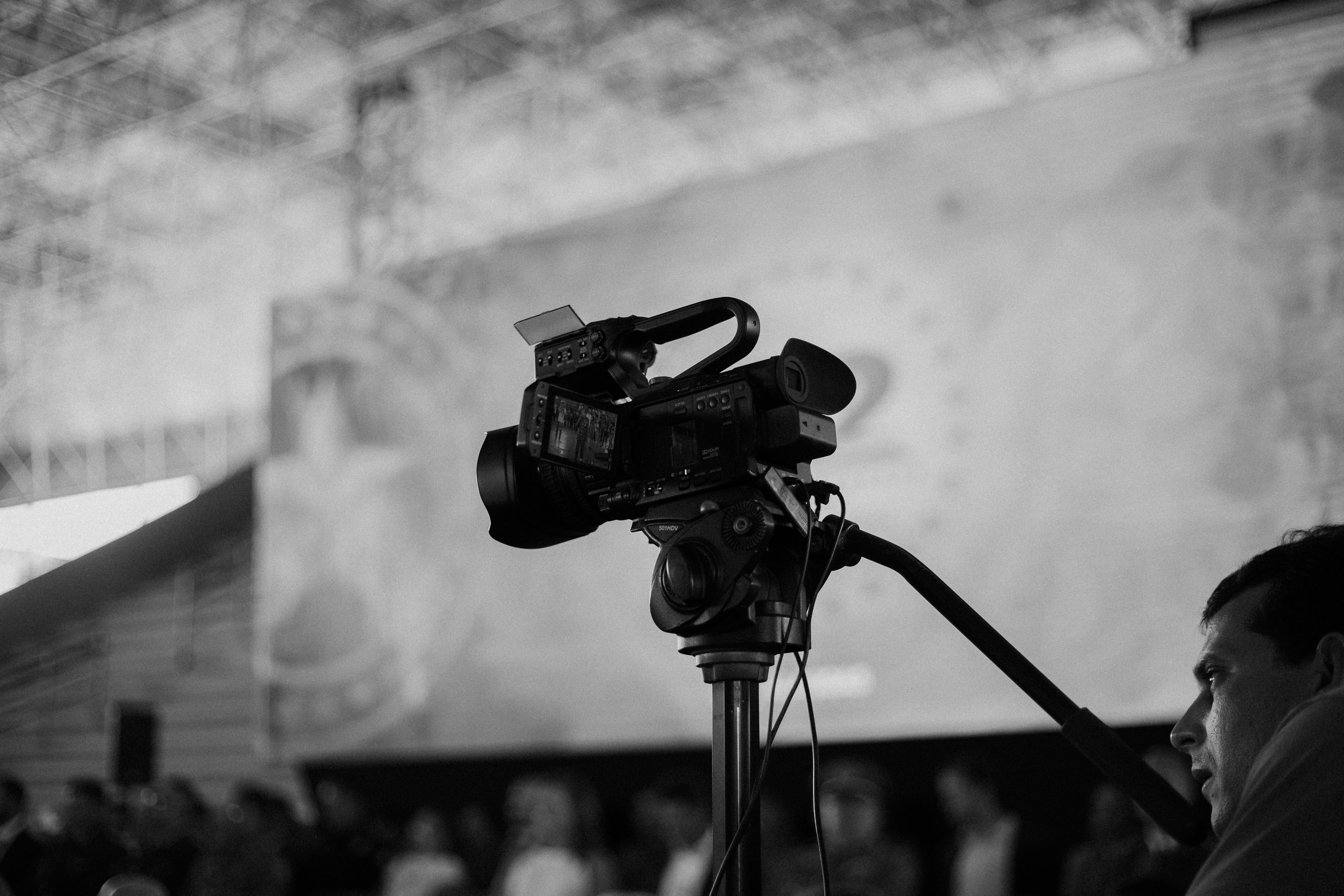 a black and white photo of a camera on a tripod