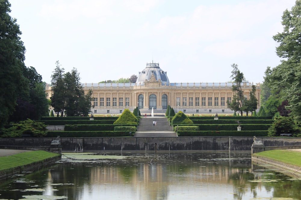 a pond in front of a large building