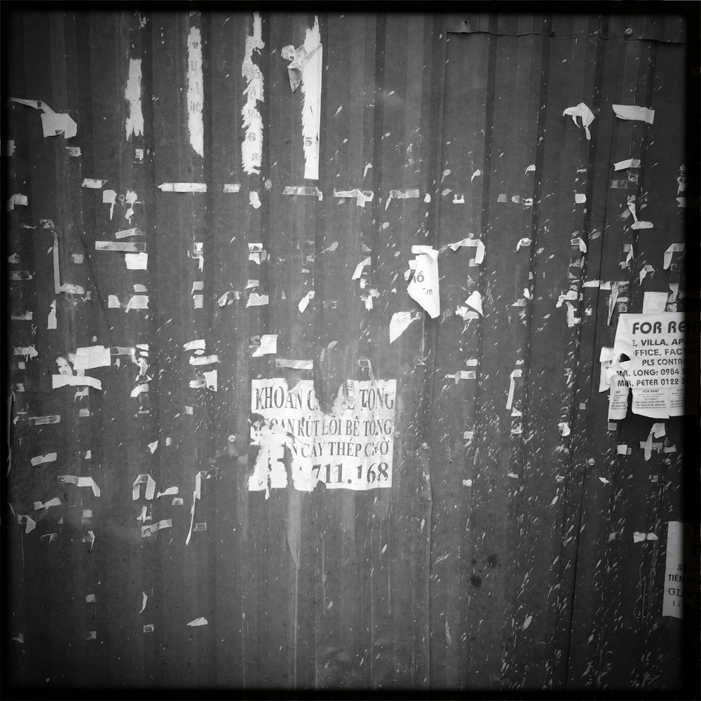 a black and white photo of a metal fence