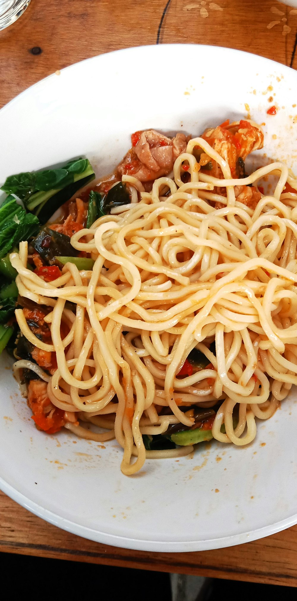 a plate of noodles and vegetables on a table