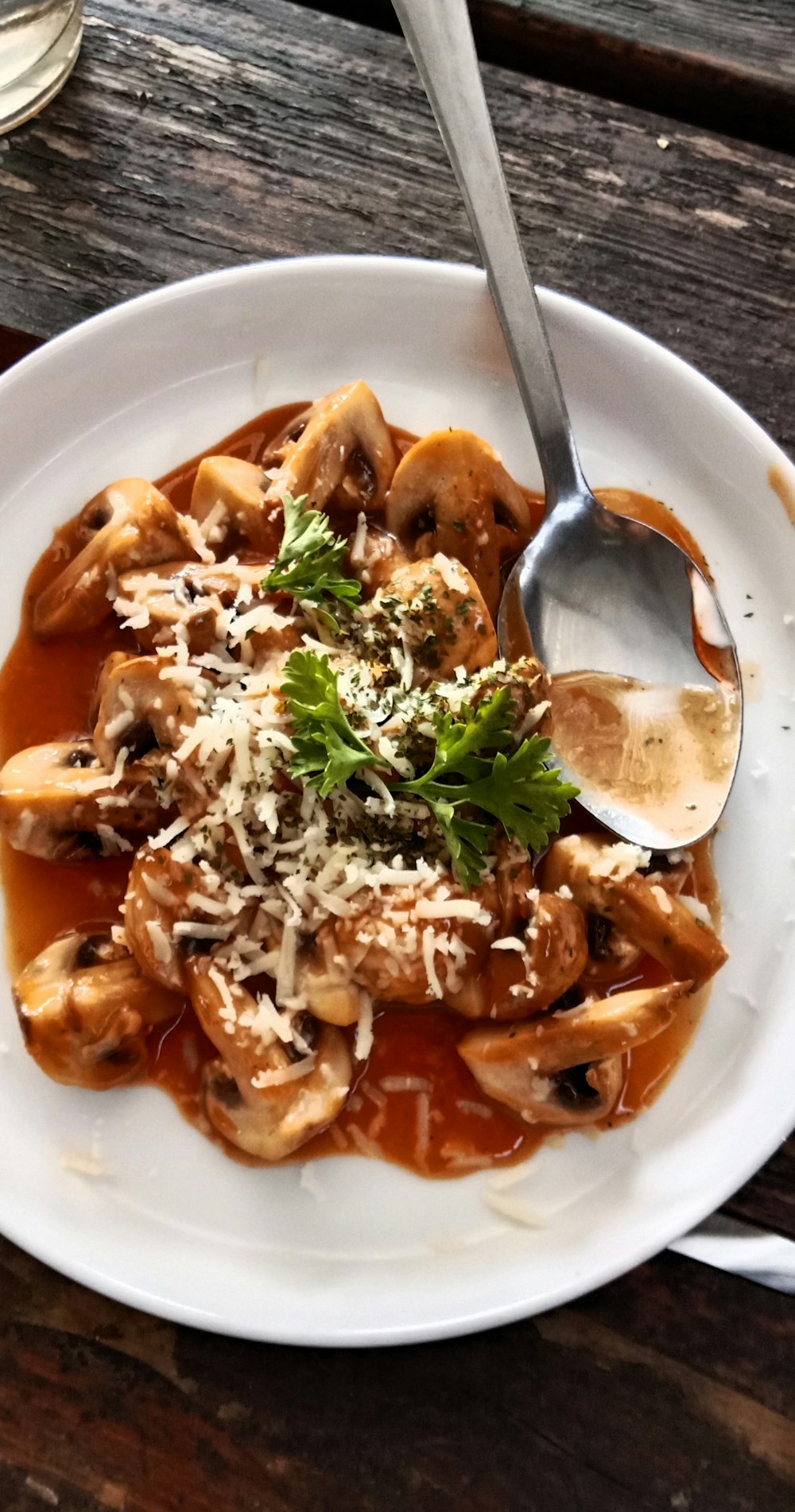 a white plate topped with pasta covered in sauce