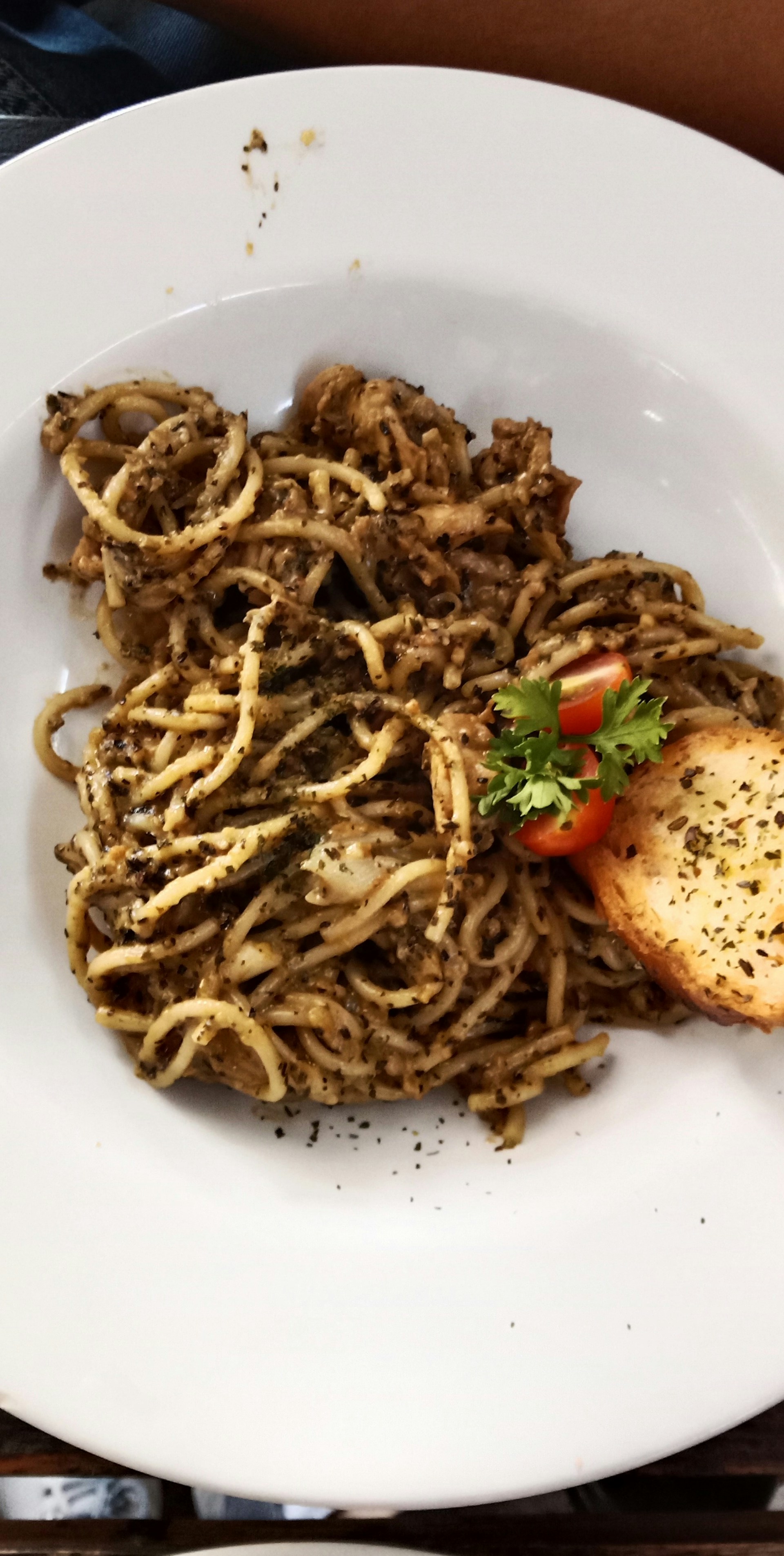 a white plate topped with spaghetti and meat