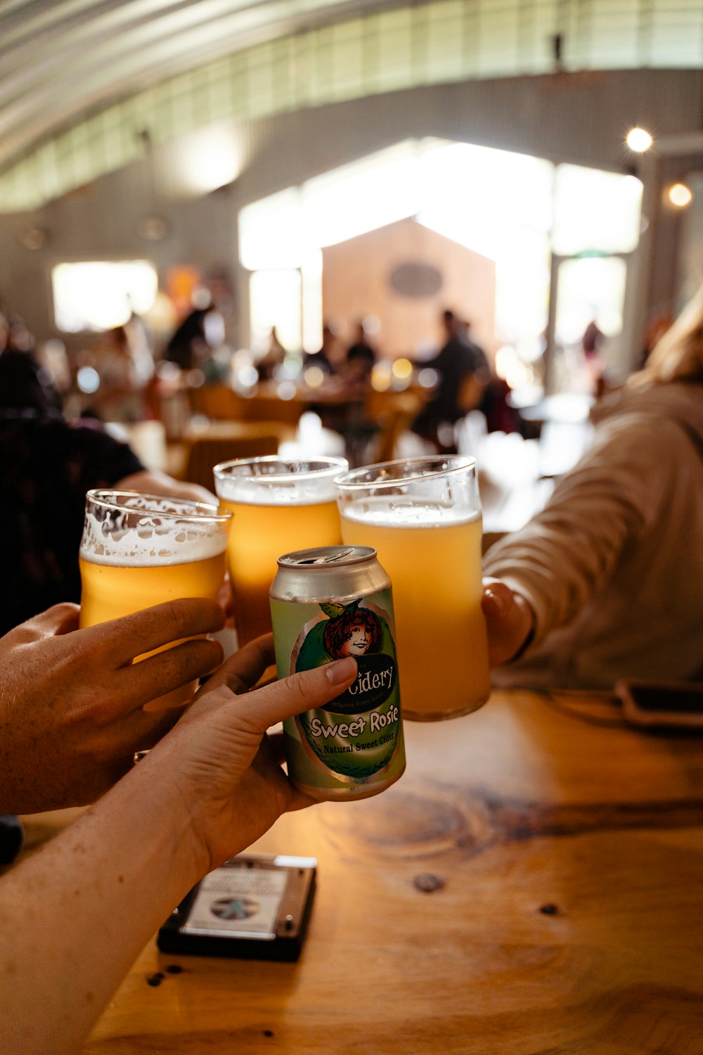 a group of people holding up beer glasses