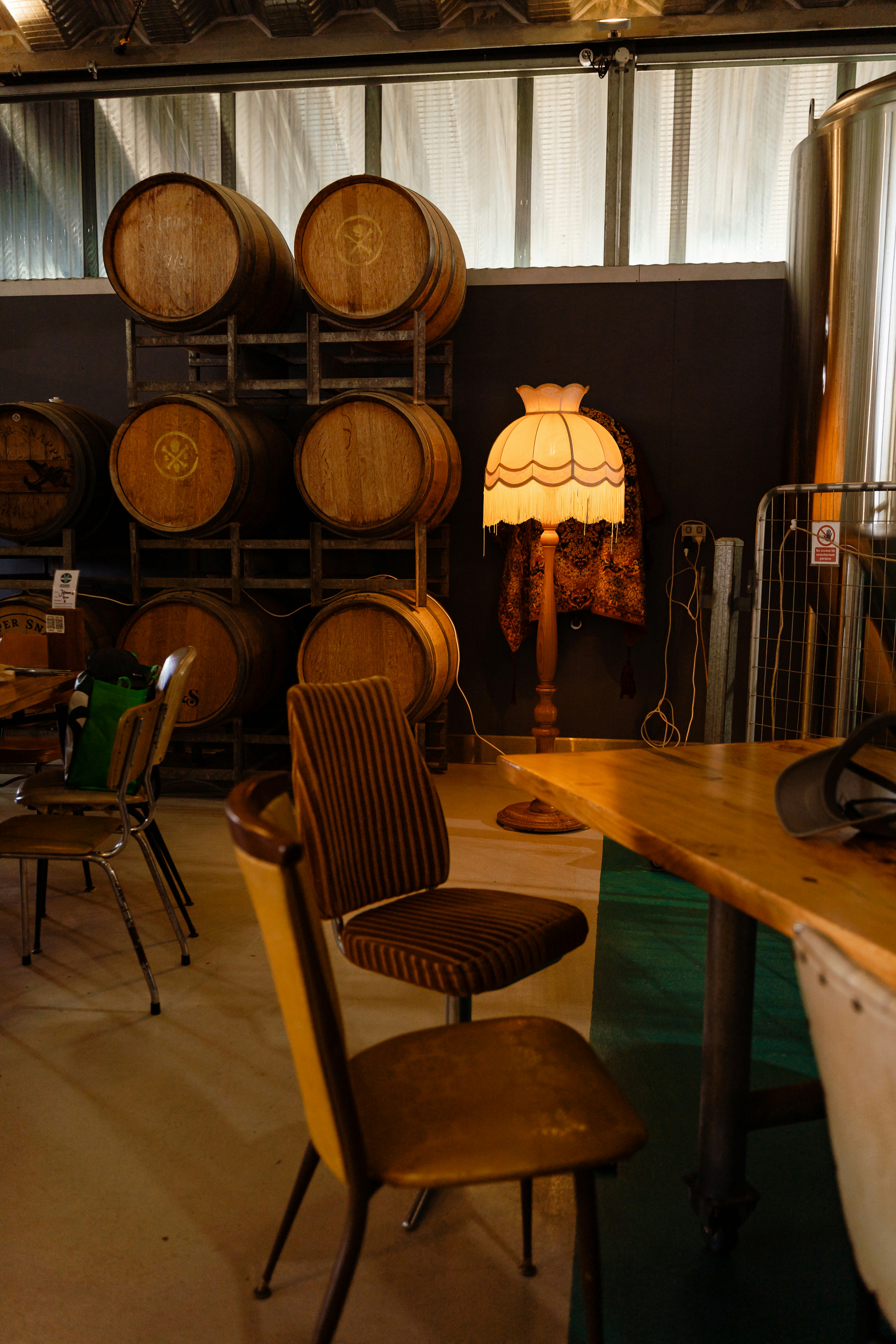 a room filled with lots of wooden barrels