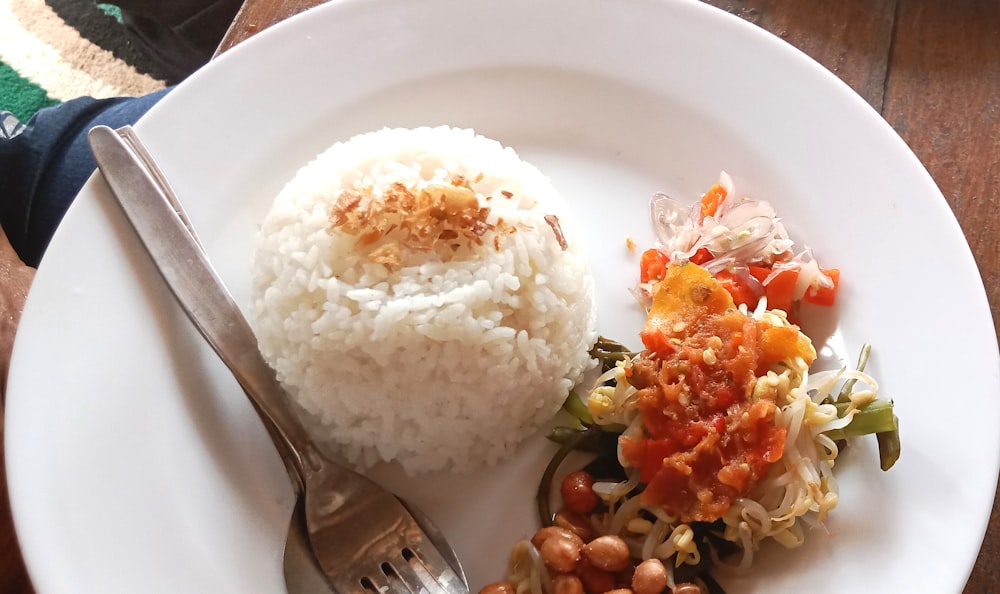 a white plate topped with rice and beans