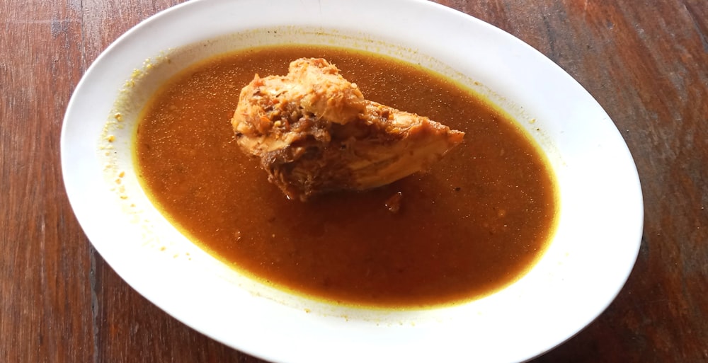 a bowl of soup on a wooden table