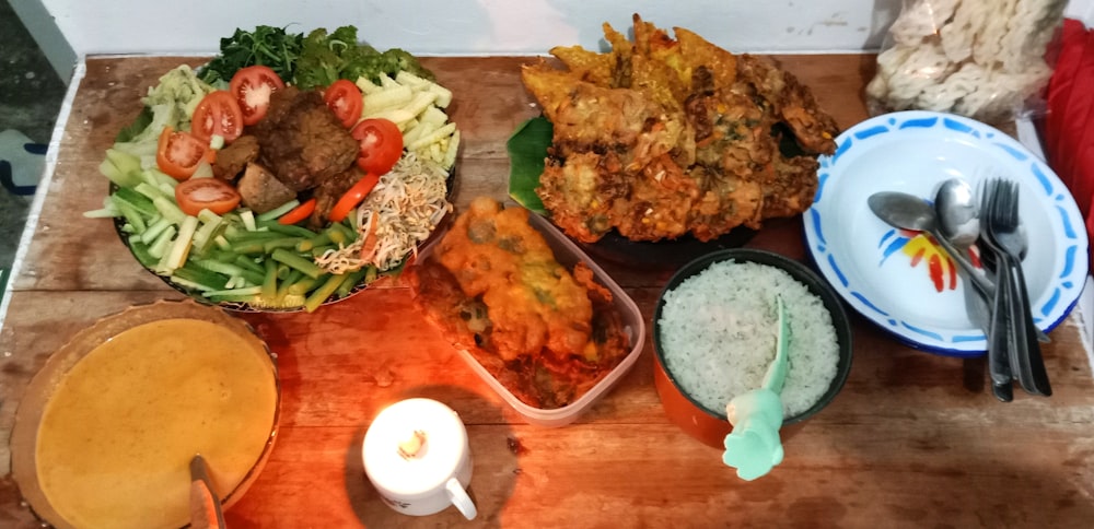 a wooden table topped with bowls of food