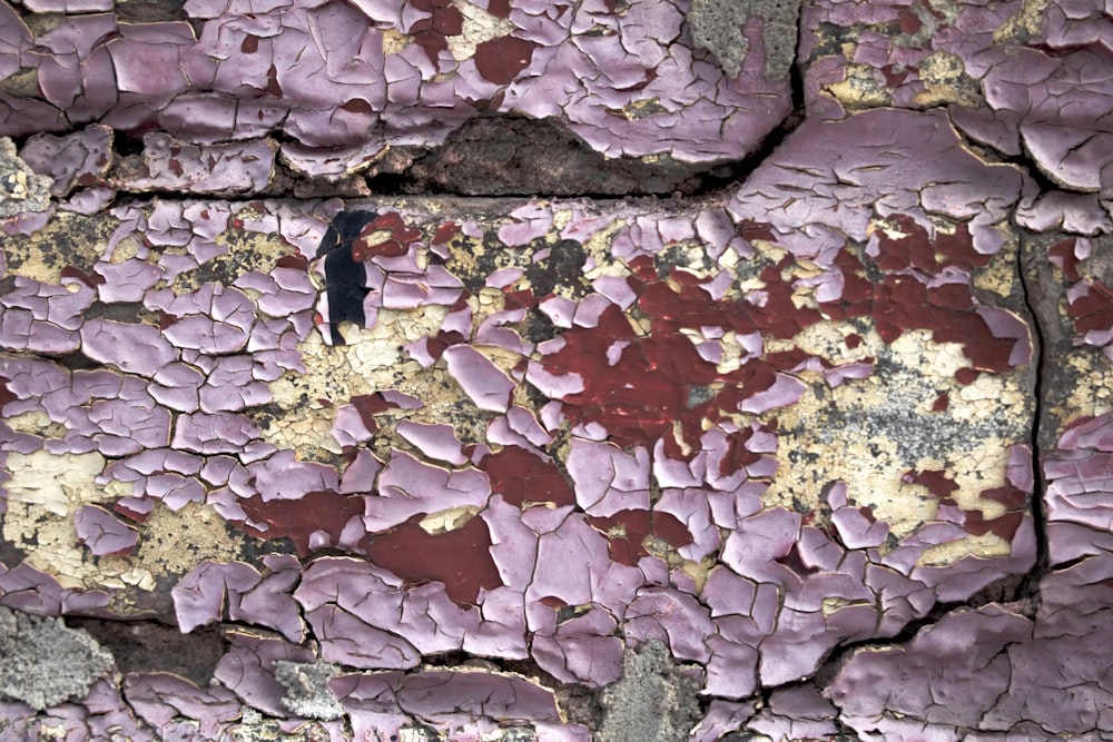 a close up of a wall with peeling paint