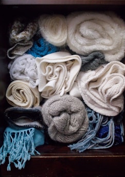 a box filled with lots of different types of scarves