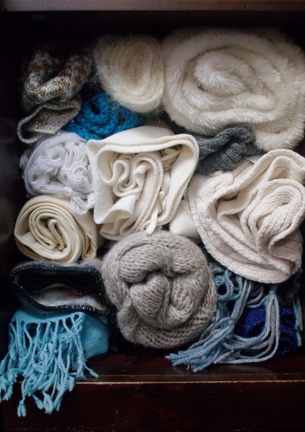 a box filled with lots of different types of scarves