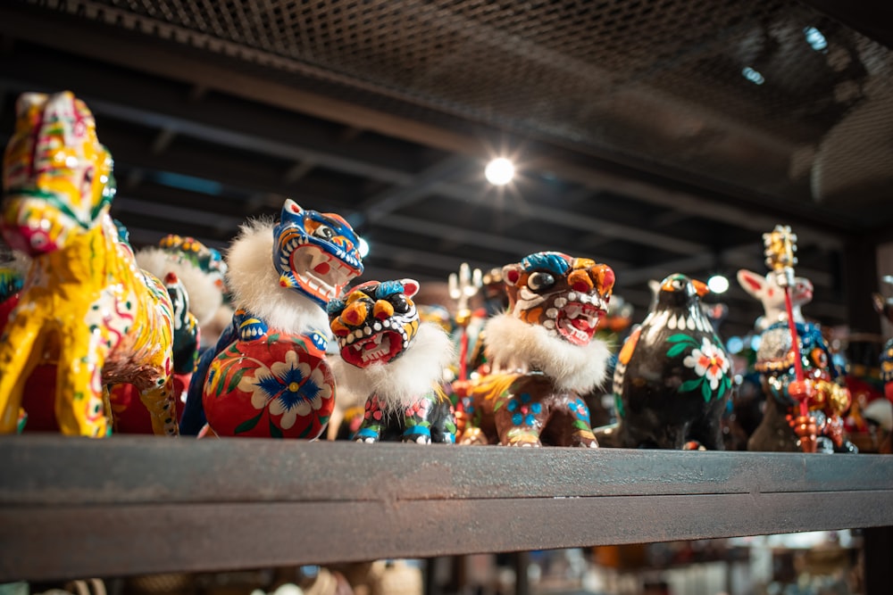 a group of colorful figurines sitting on top of a shelf
