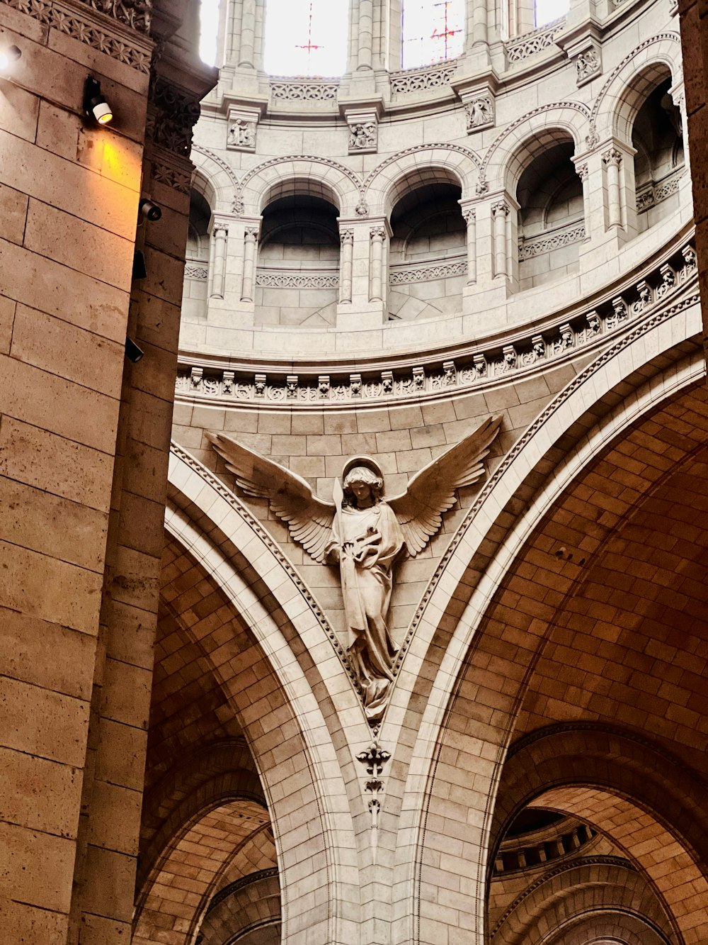 a statue of an angel on the side of a building