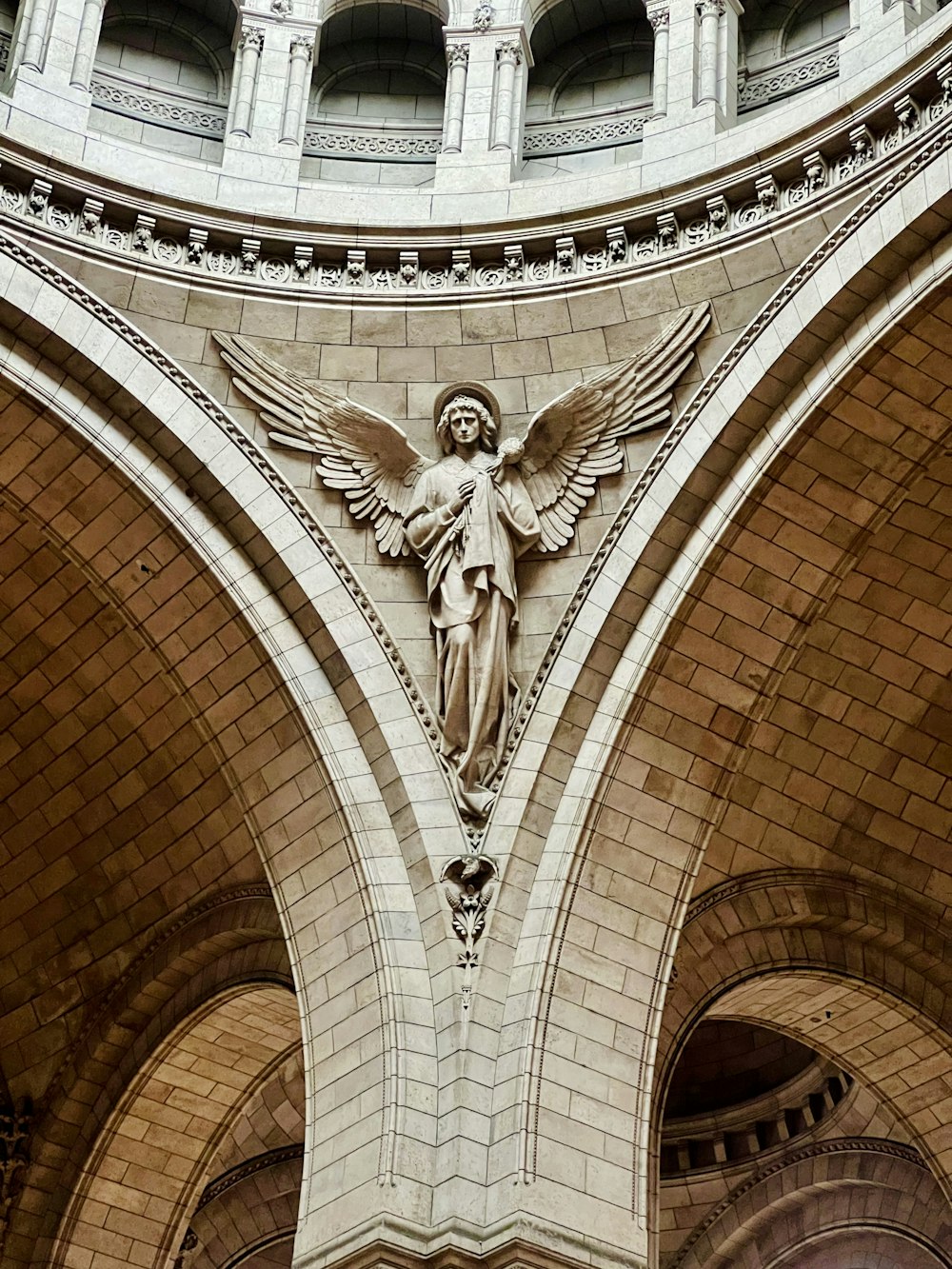 a statue of an angel on the side of a building