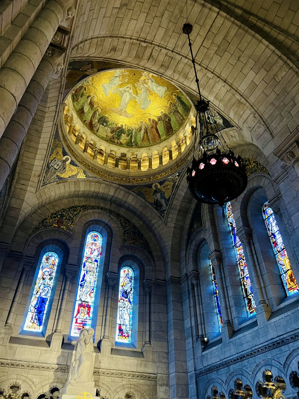 a church with stained glass windows and a chandelier