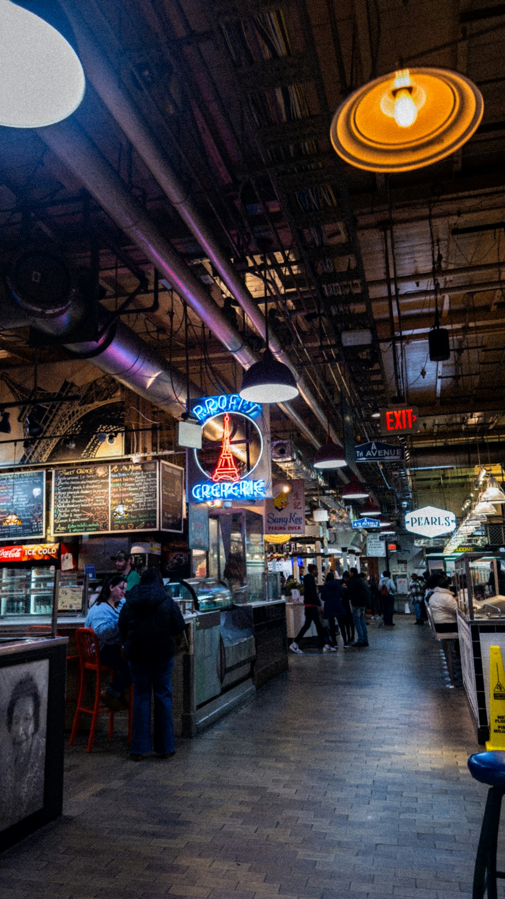 a food court with people eating and drinking