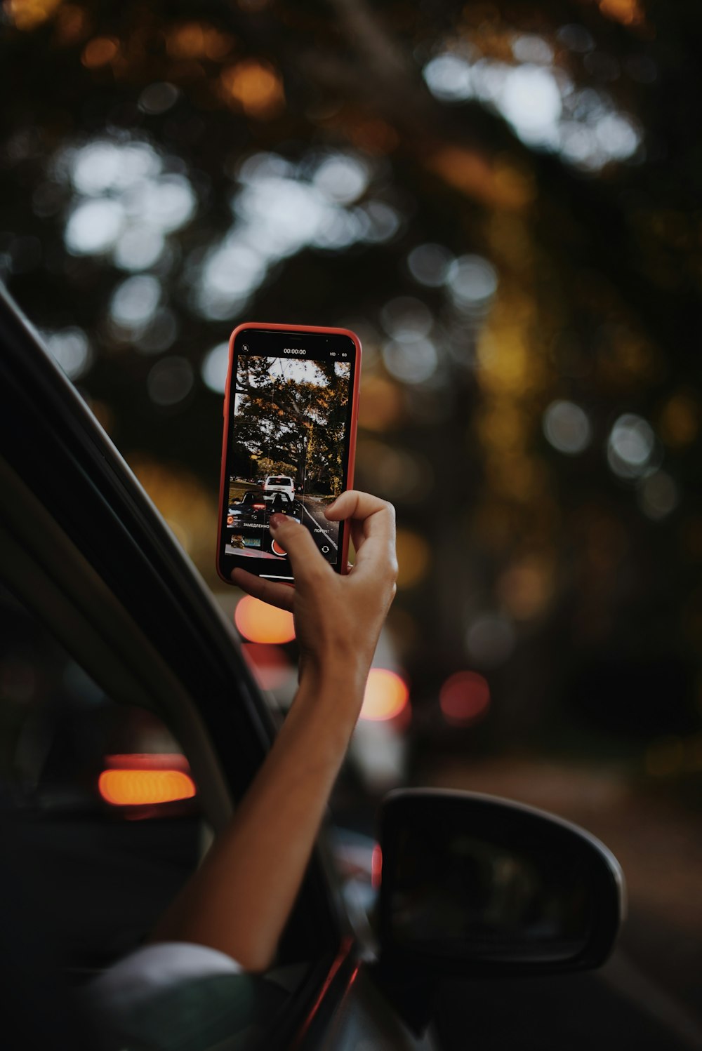 a person taking a picture of a street with a cell phone