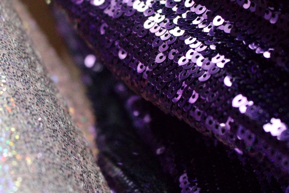 a close up of a purple sequin fabric