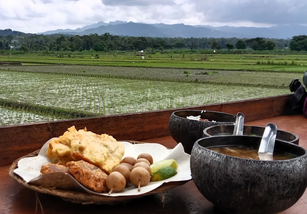 a plate of food sitting on top of a wooden table