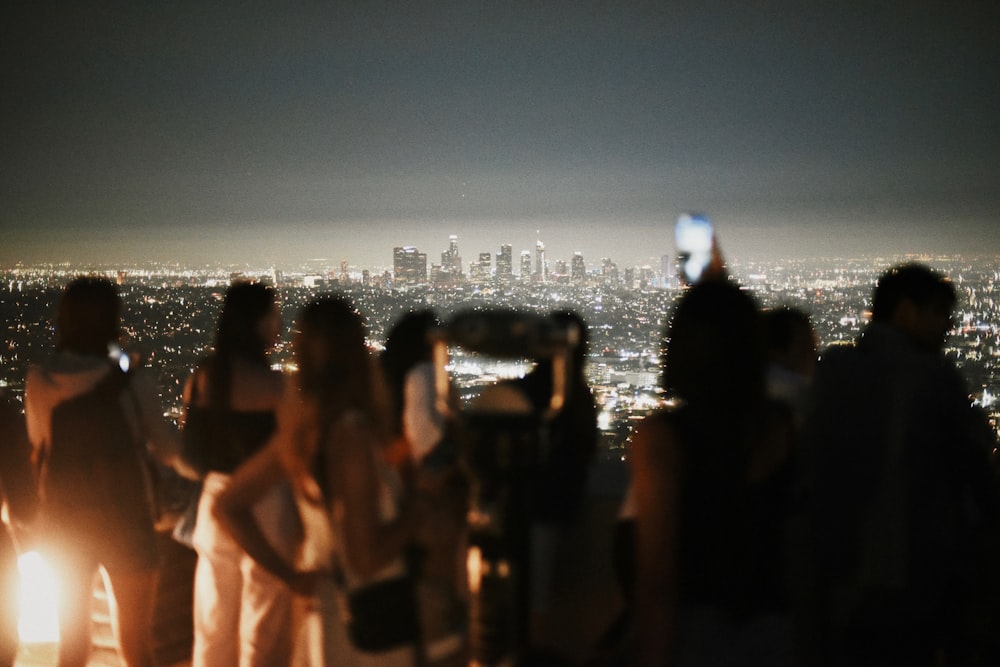 a group of people standing on top of a tall building