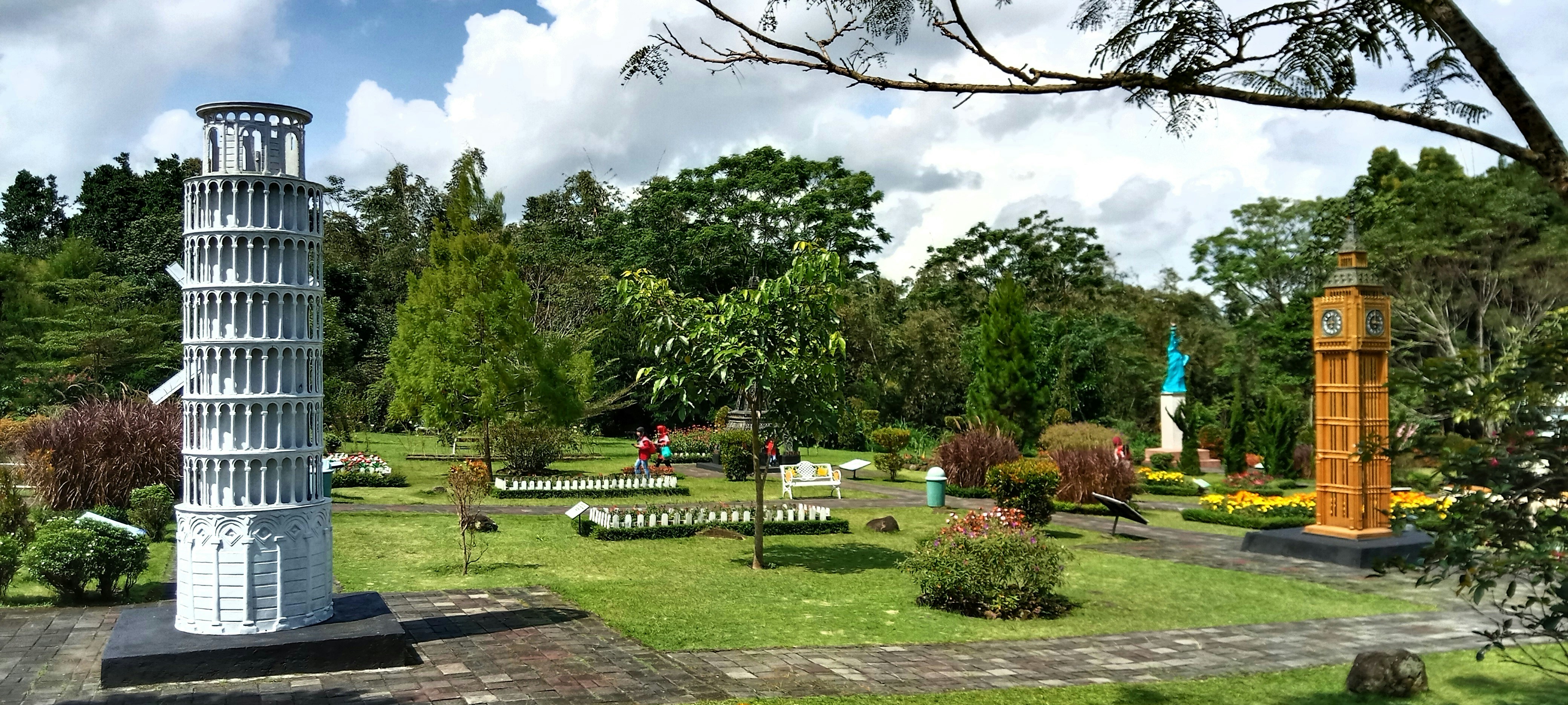 a statue of a tower in a park