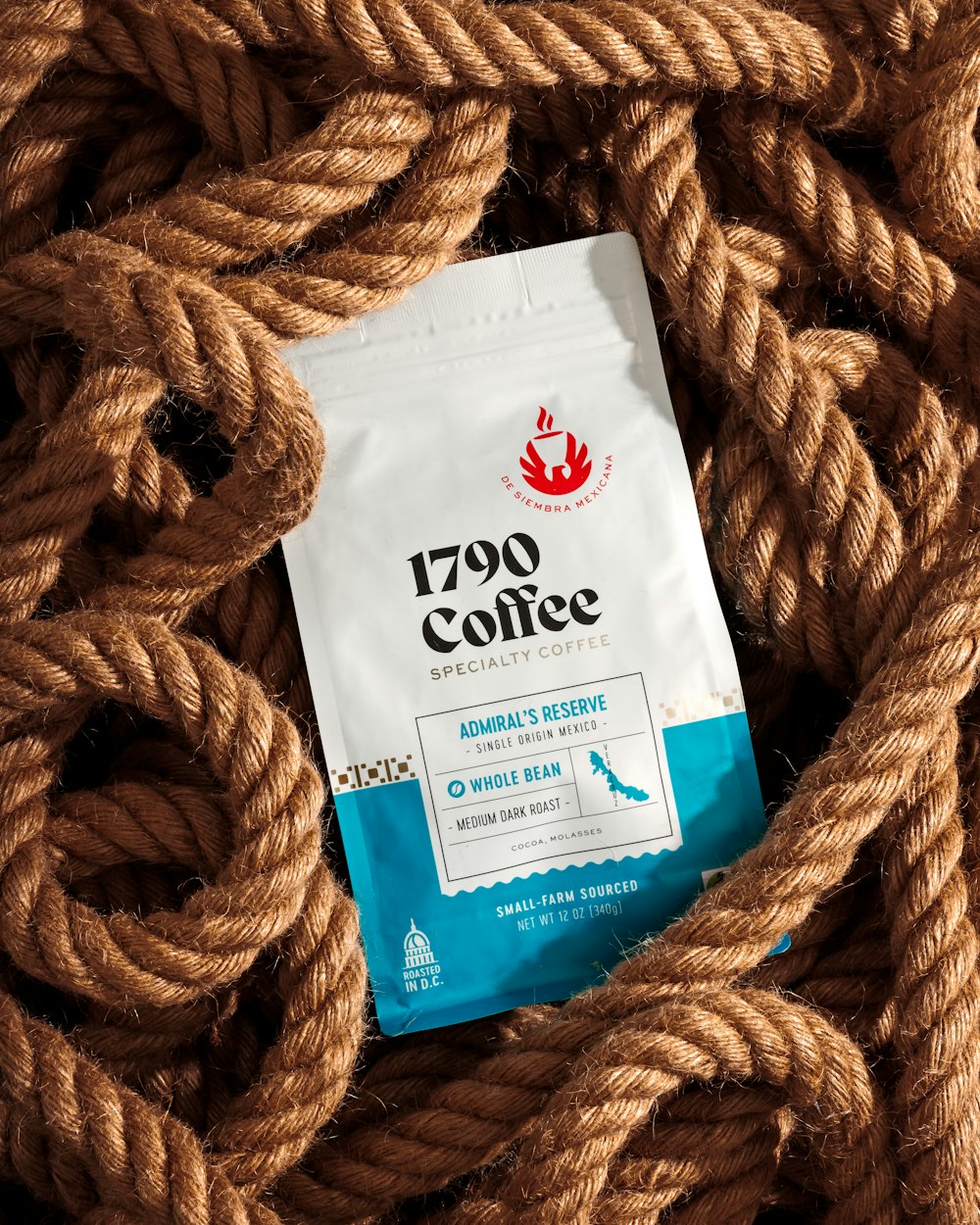 a bag of coffee sitting on top of a rope