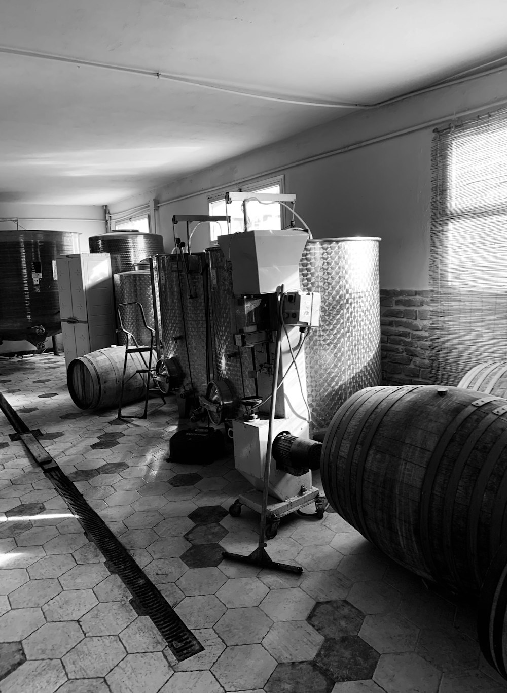 a black and white photo of a room with barrels