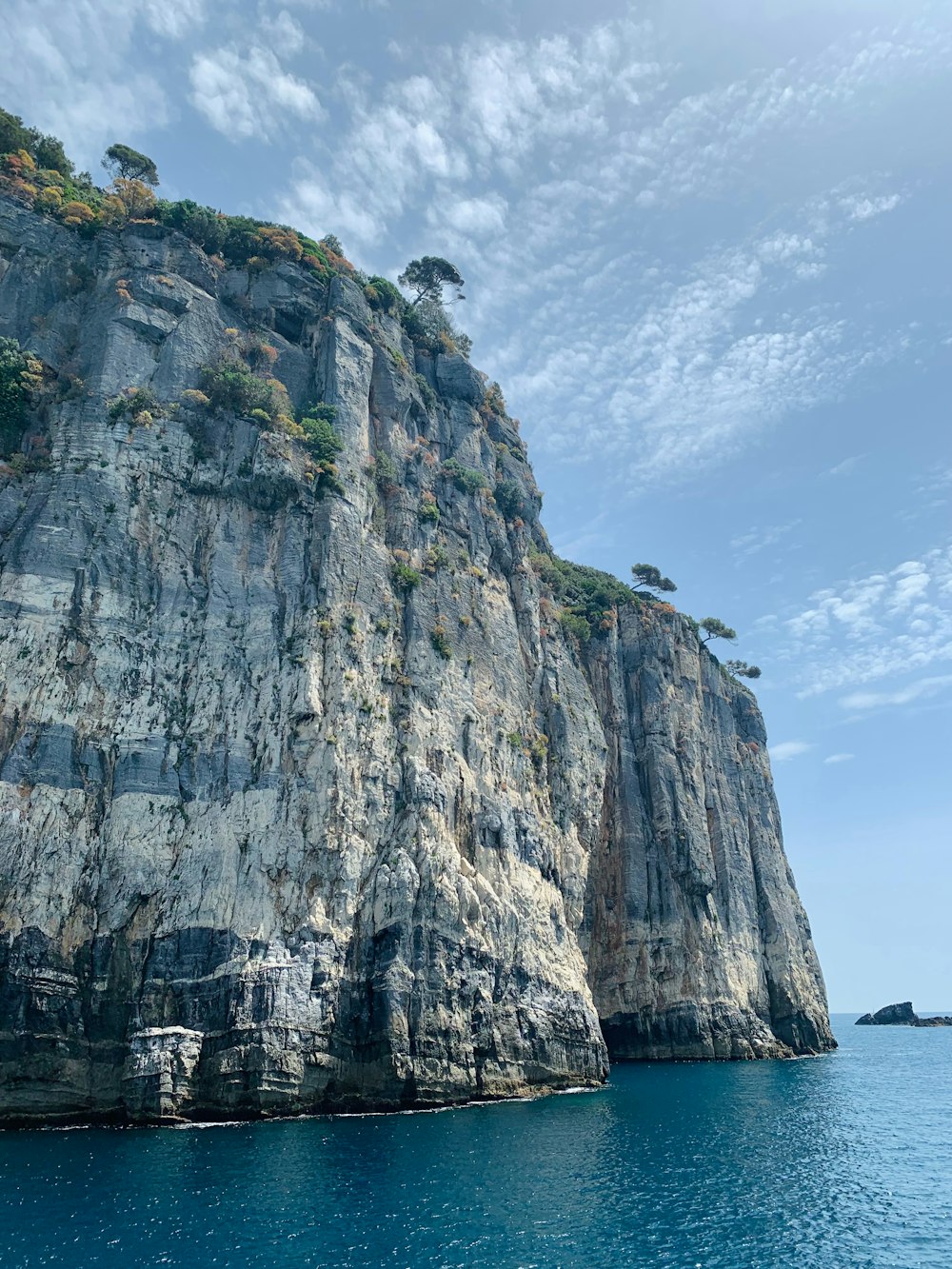 a large rock outcropping in the middle of a body of water