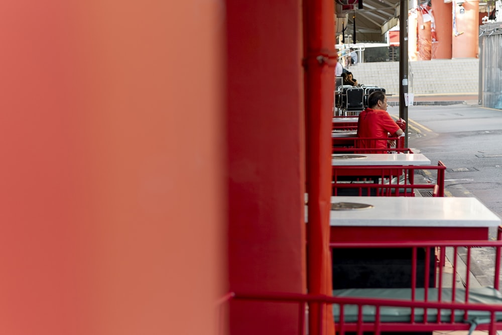 a row of red tables sitting next to each other