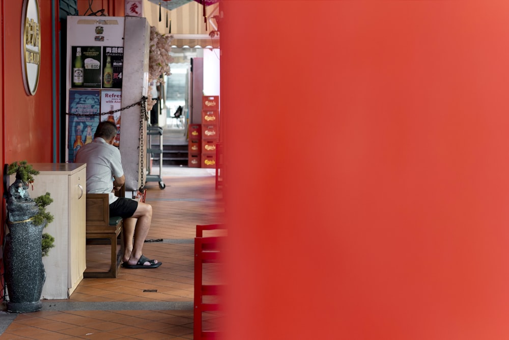 a man sitting on a bench in a building