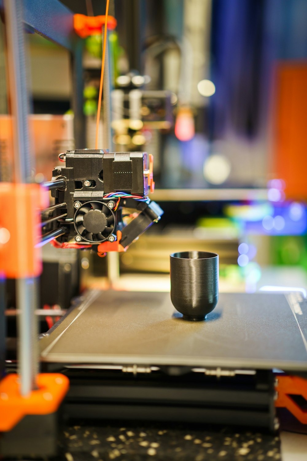 a 3d printer with a cup on top of it