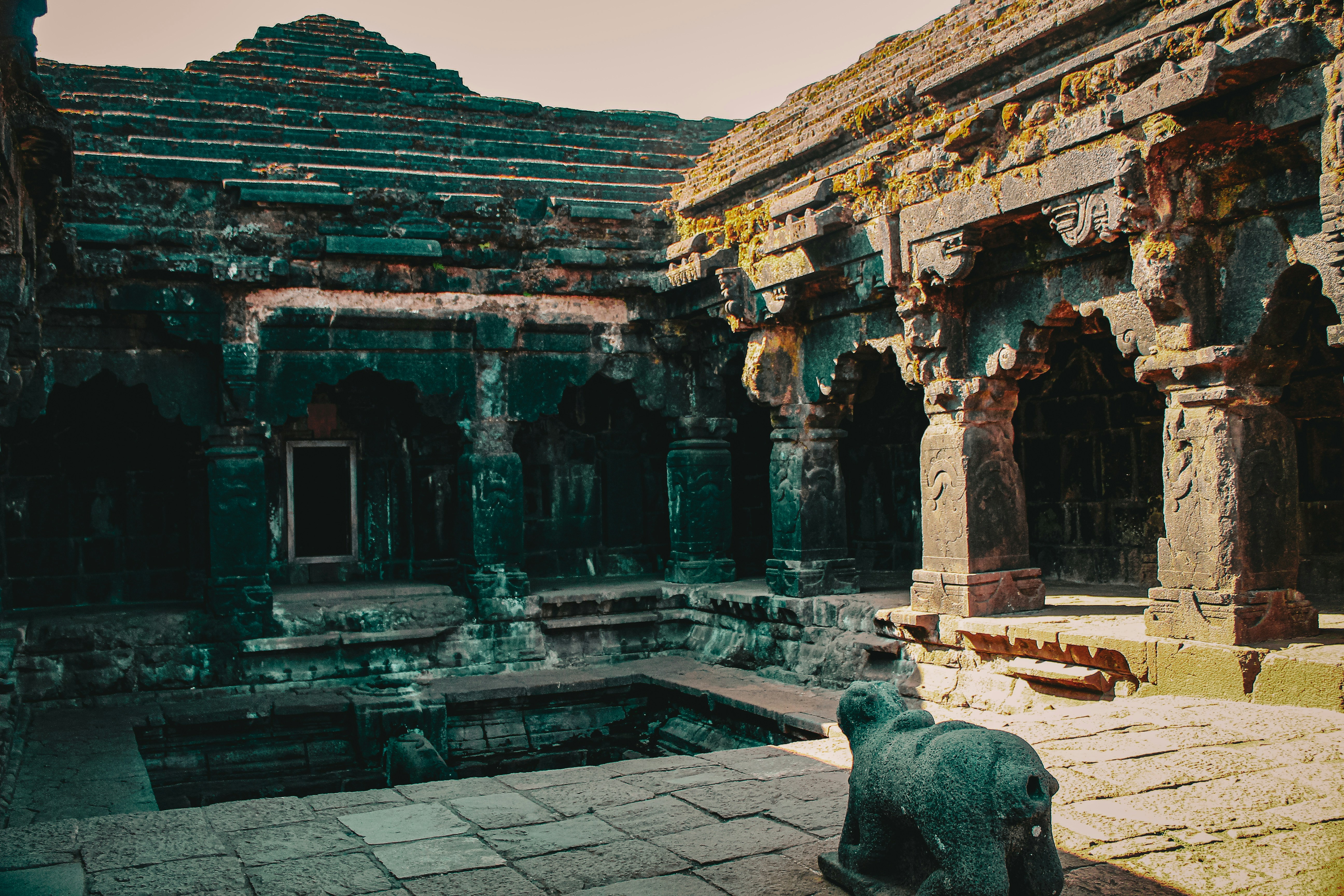a statue of a dog in a stone courtyard