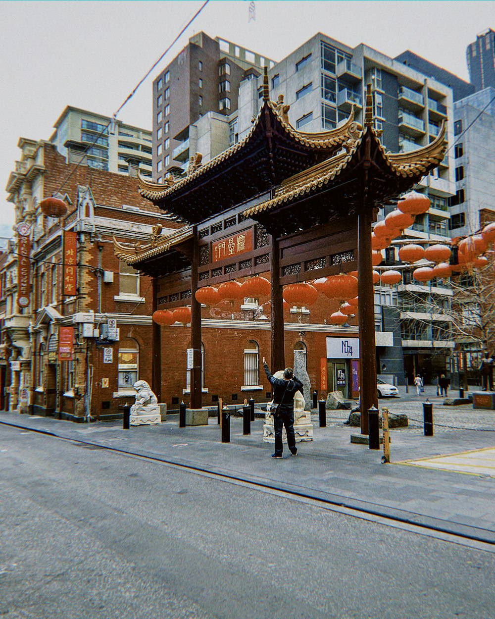 a man standing in front of a tall building