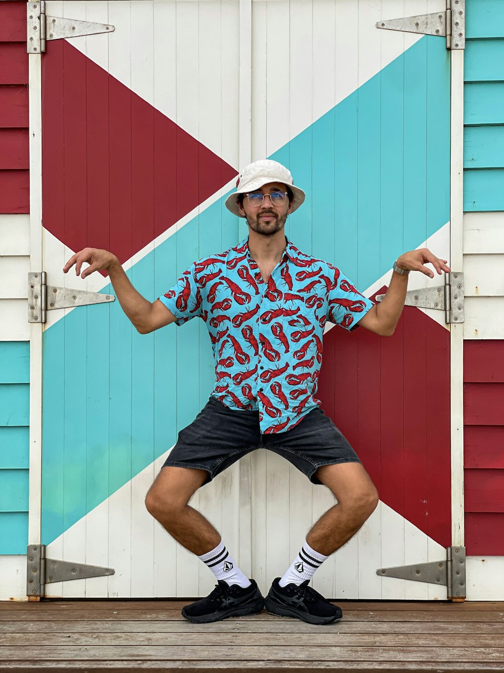 a man standing in front of a colorful wall