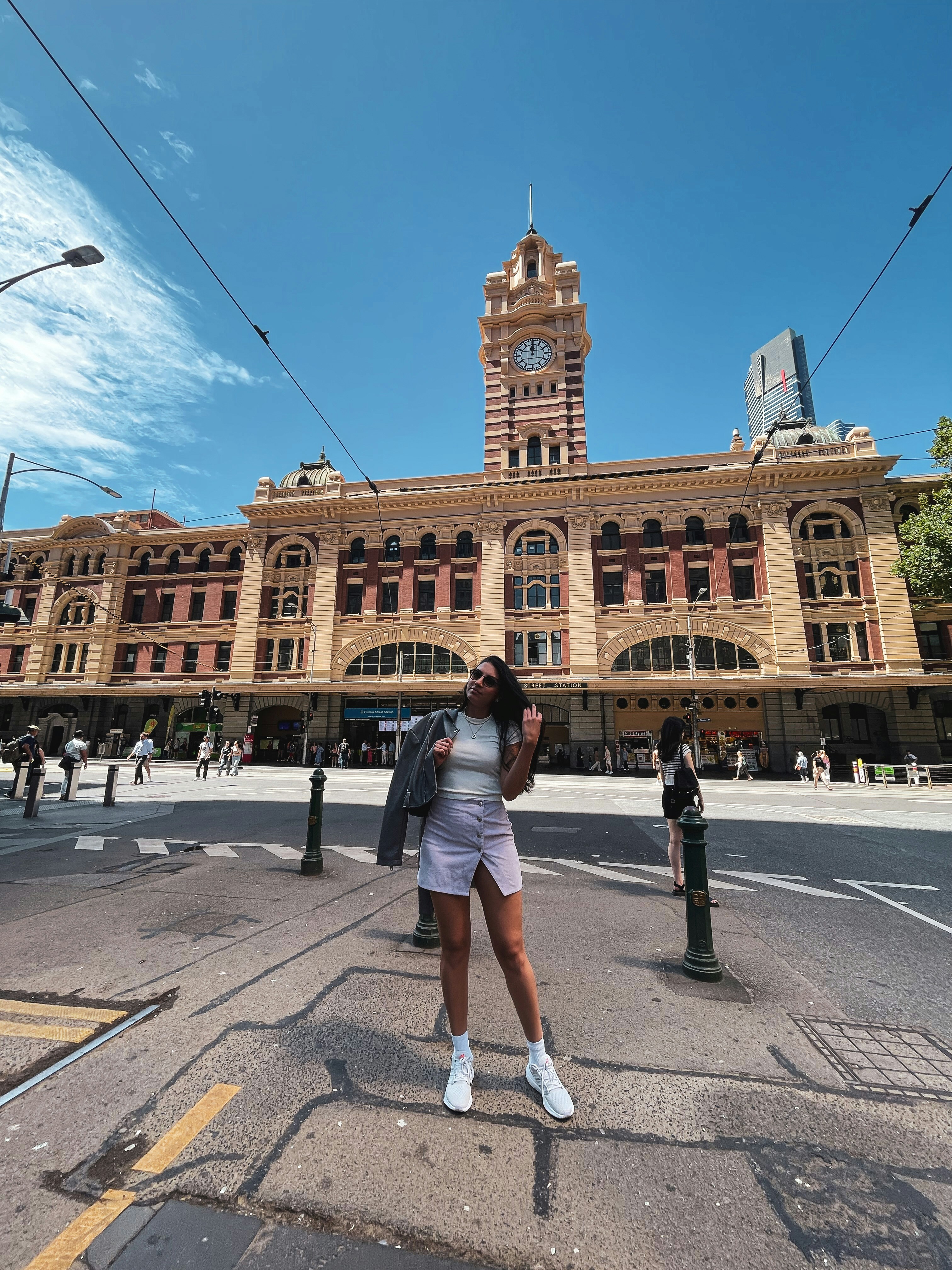 a woman standing in front of a large building