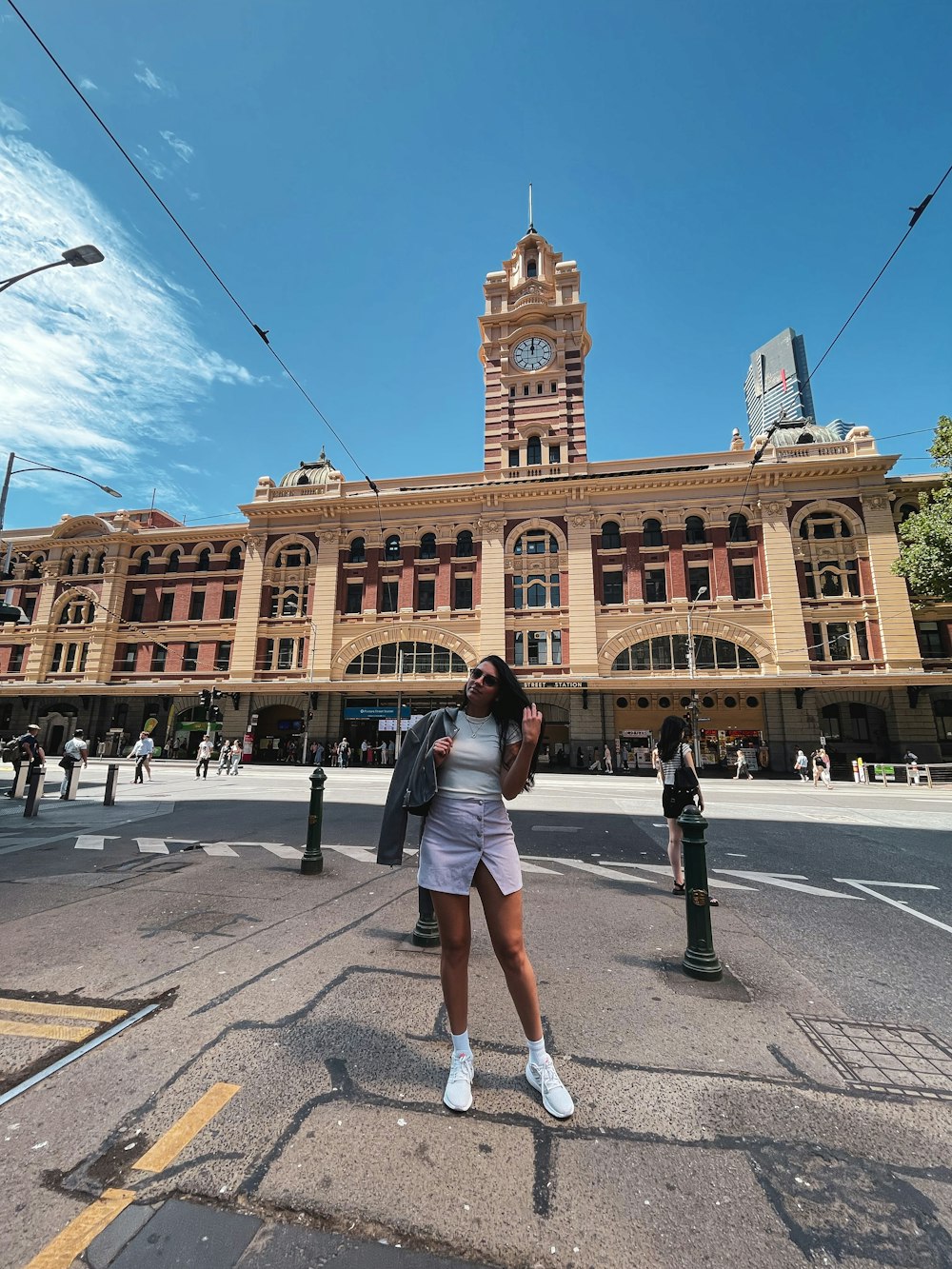 a woman standing in front of a large building