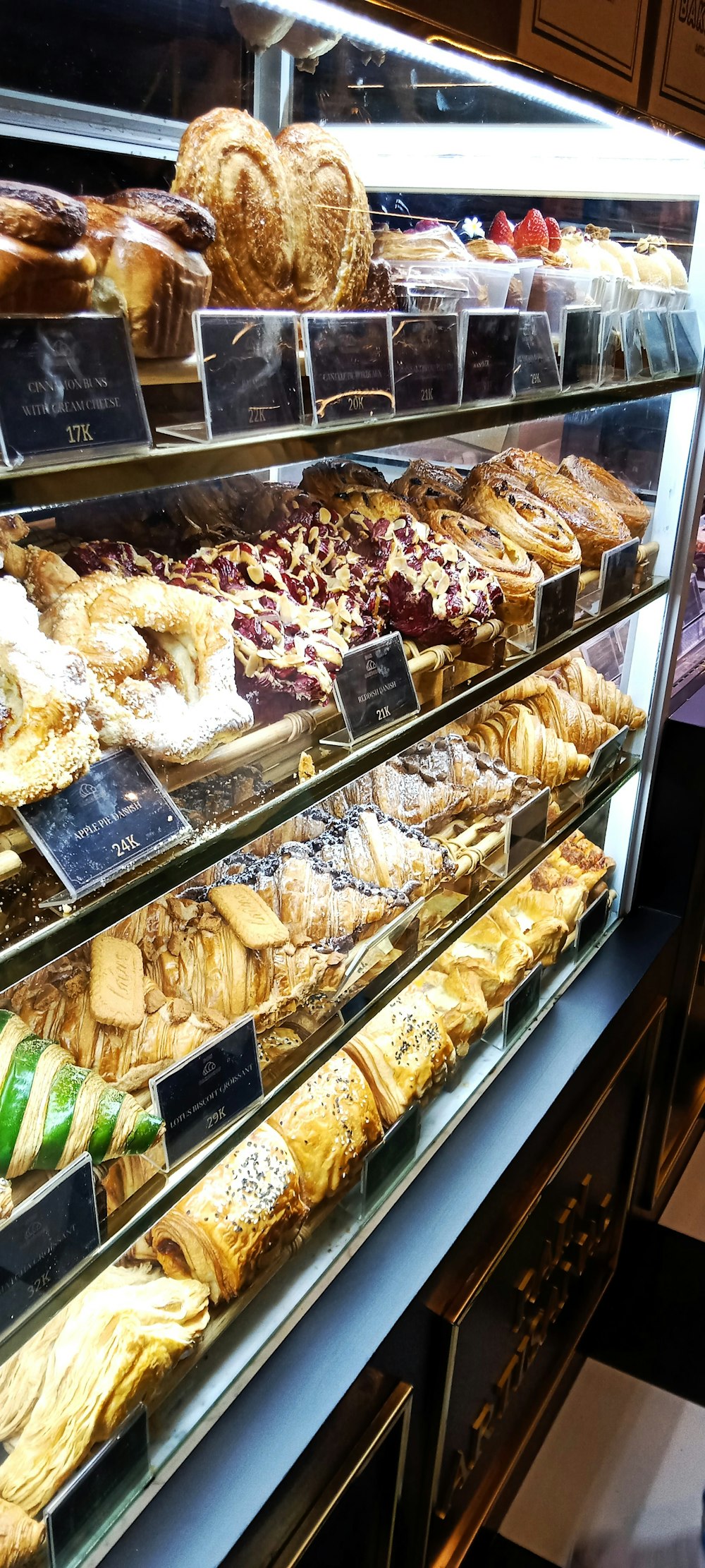 a display case filled with lots of different types of pastries