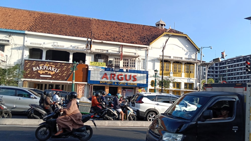 a group of people riding motorcycles down a street