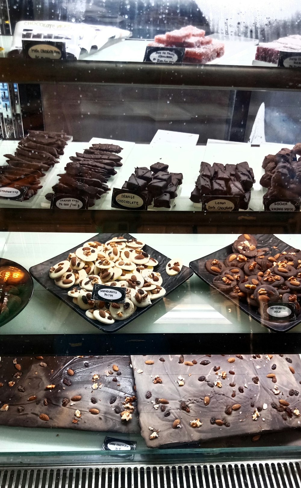 a display case filled with lots of different types of desserts