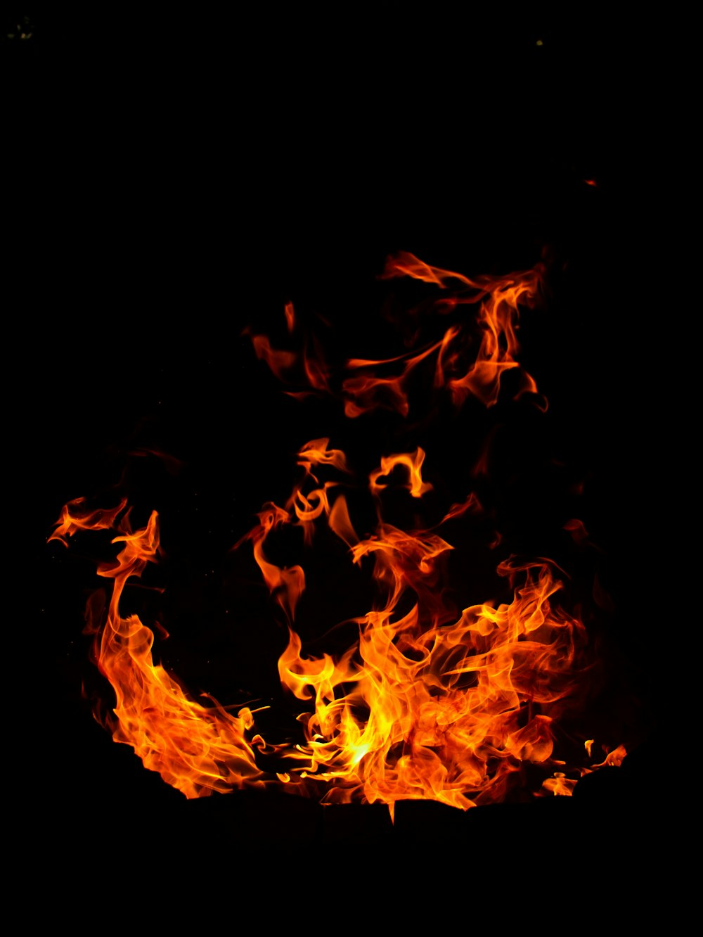 a fire is burning in the dark on a black background