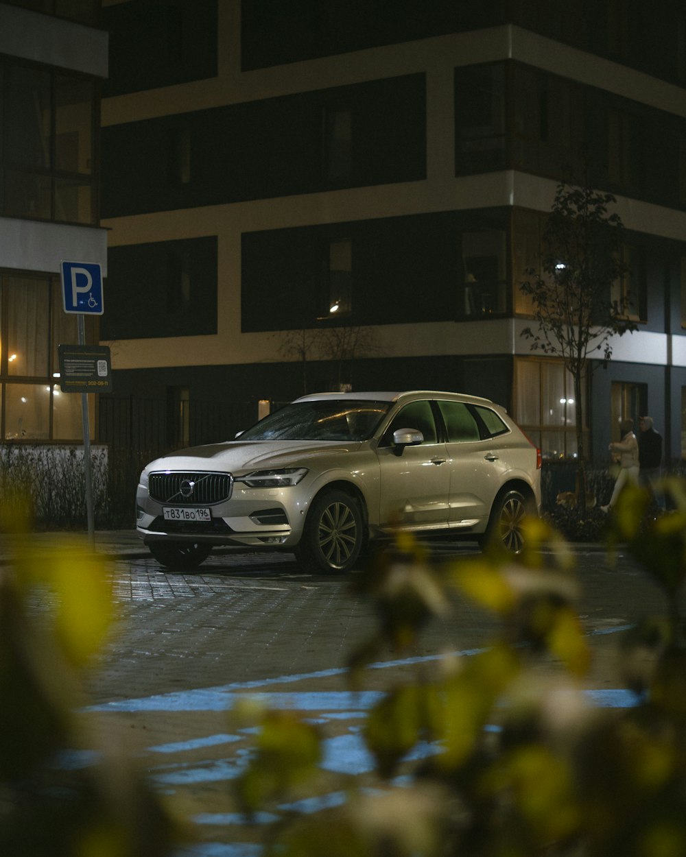 a car parked in front of a building at night