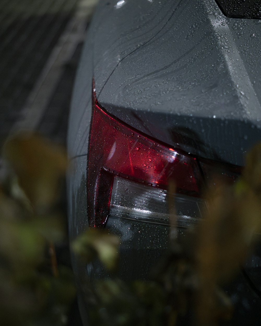 a close up of a car with rain on it