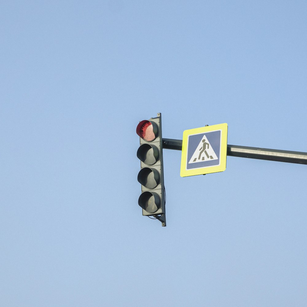 a traffic light on a pole with a sign on it