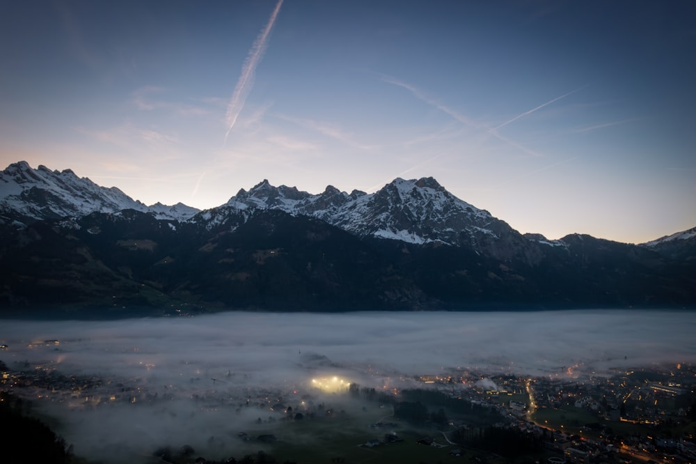 a view of a city below a mountain range