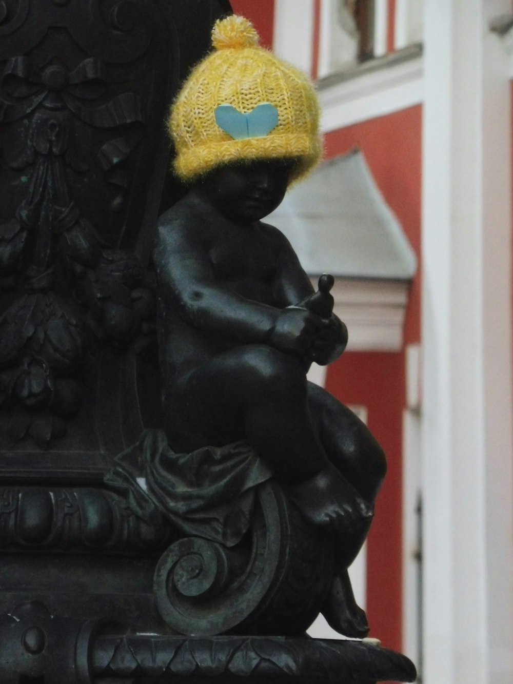 a statue with a knitted hat on top of it