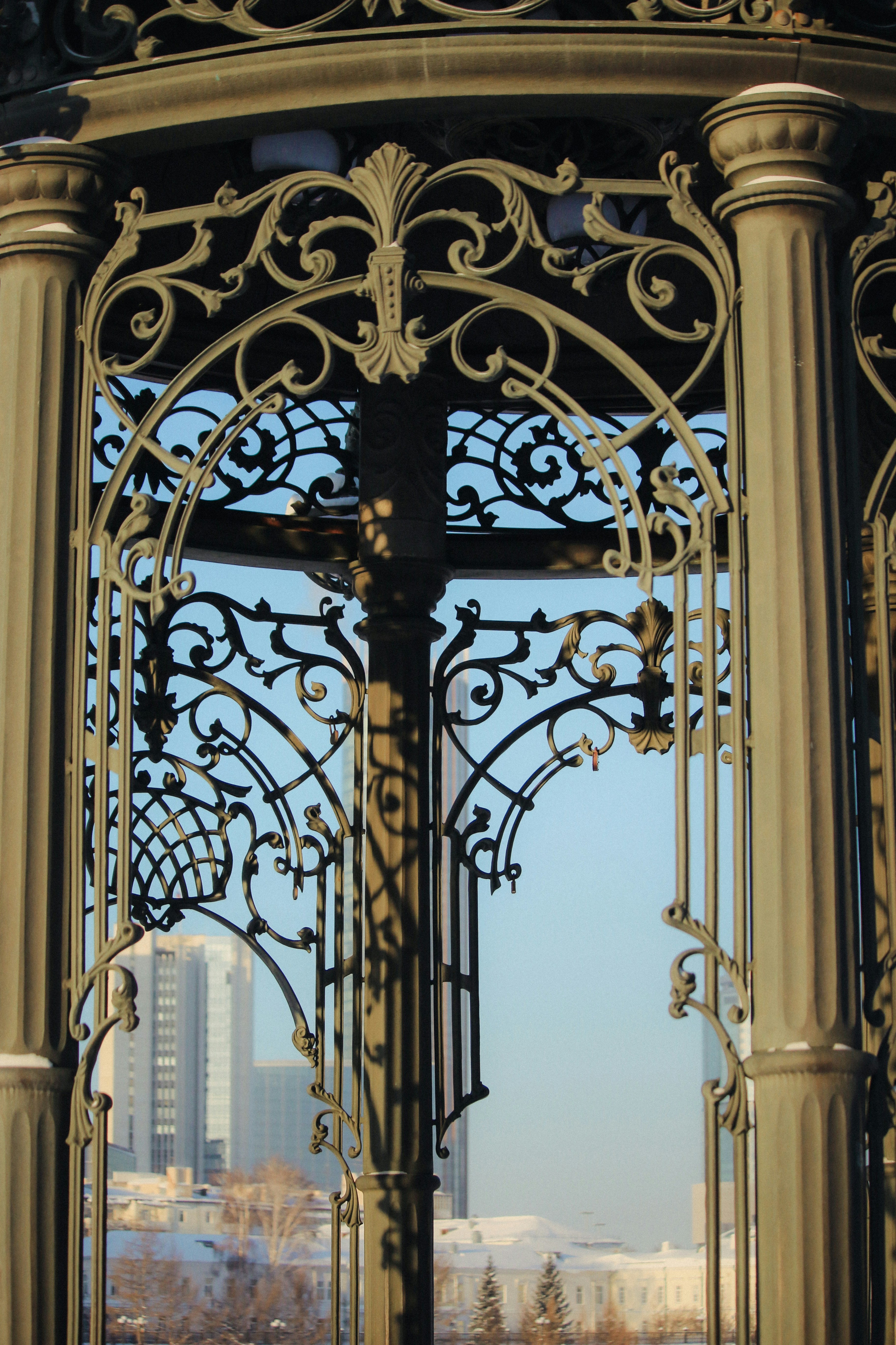 a large metal structure with a clock on top of it